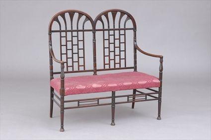 Appraisal: AESTHETIC MOVEMENT DOUBLE CHAIR-BACK SETTEE The back with stylized papyrus