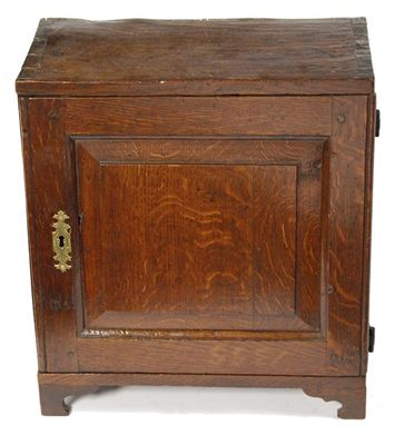 Appraisal: An early th century oak spice cupboard with a hinged