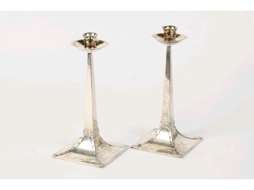 Appraisal: A PAIR OF SILVER ARTS AND CRAFTS CANDLESTICKS with broad