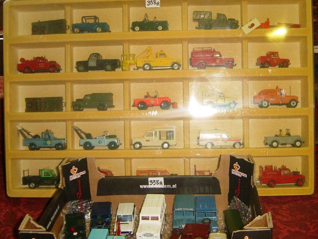 Appraisal: A wall cabinet containing model Land Rovers in varying livery