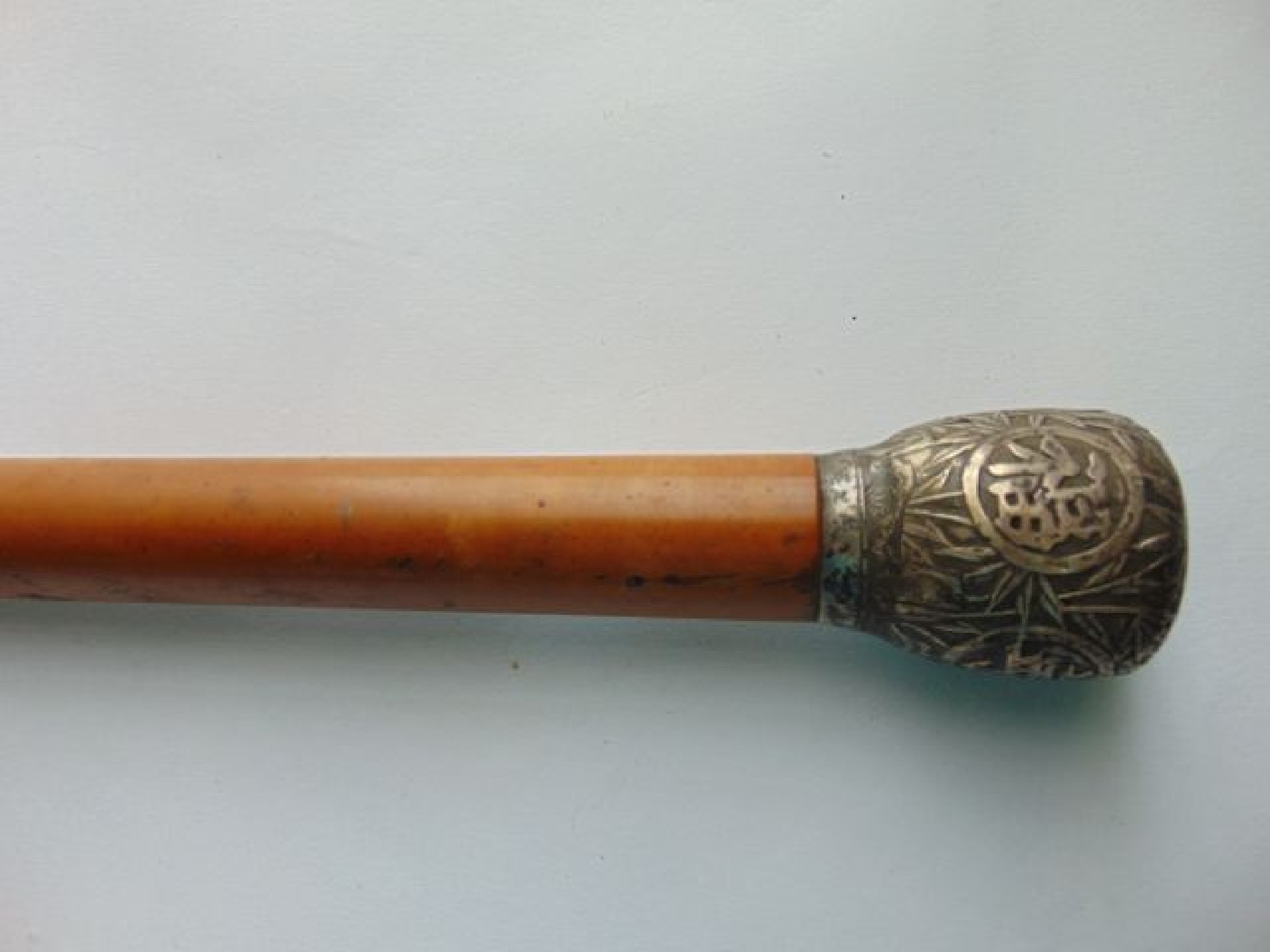 Appraisal: A simple polished Malacca walking cane terminating in an applied