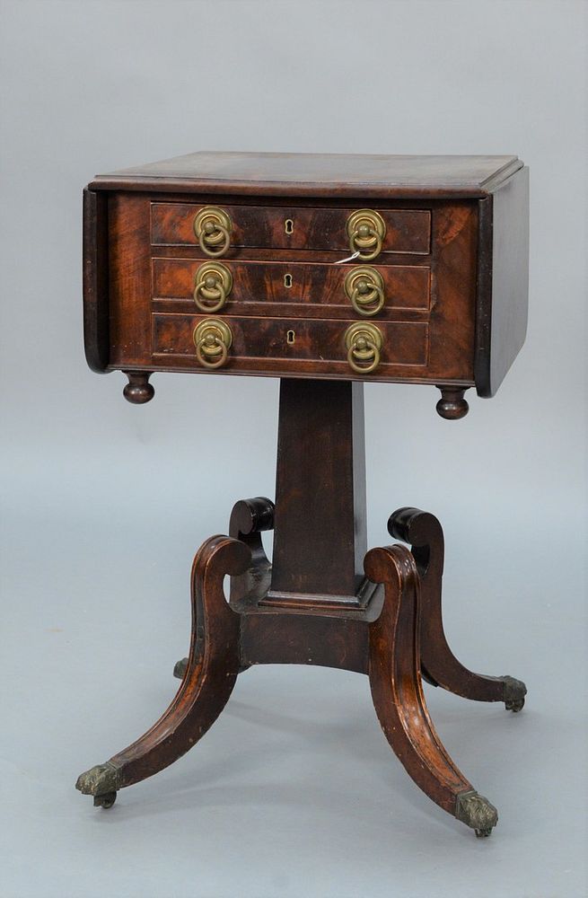 Appraisal: Duncan Phyfe Mahogany Drop Leaf Stand with three drawers on