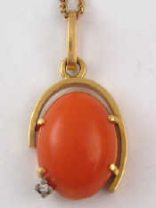 Appraisal: A yellow metal tests carat gold coral and diamond pendant