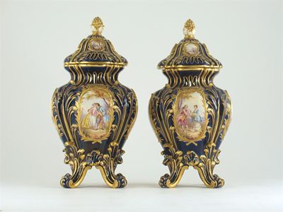 Appraisal: A pair of S vres-style Continental vases and covers decorated