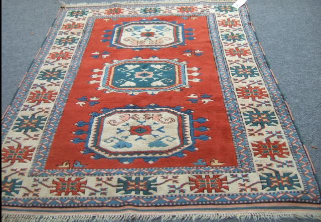 Appraisal: A Kazak style rug Turkish modern the red field with