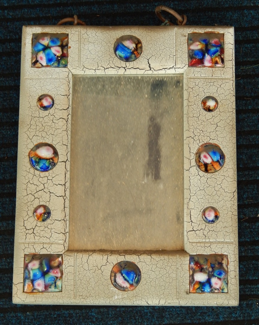 Appraisal: A decorative thC cream painted mirror applied overall with enamel