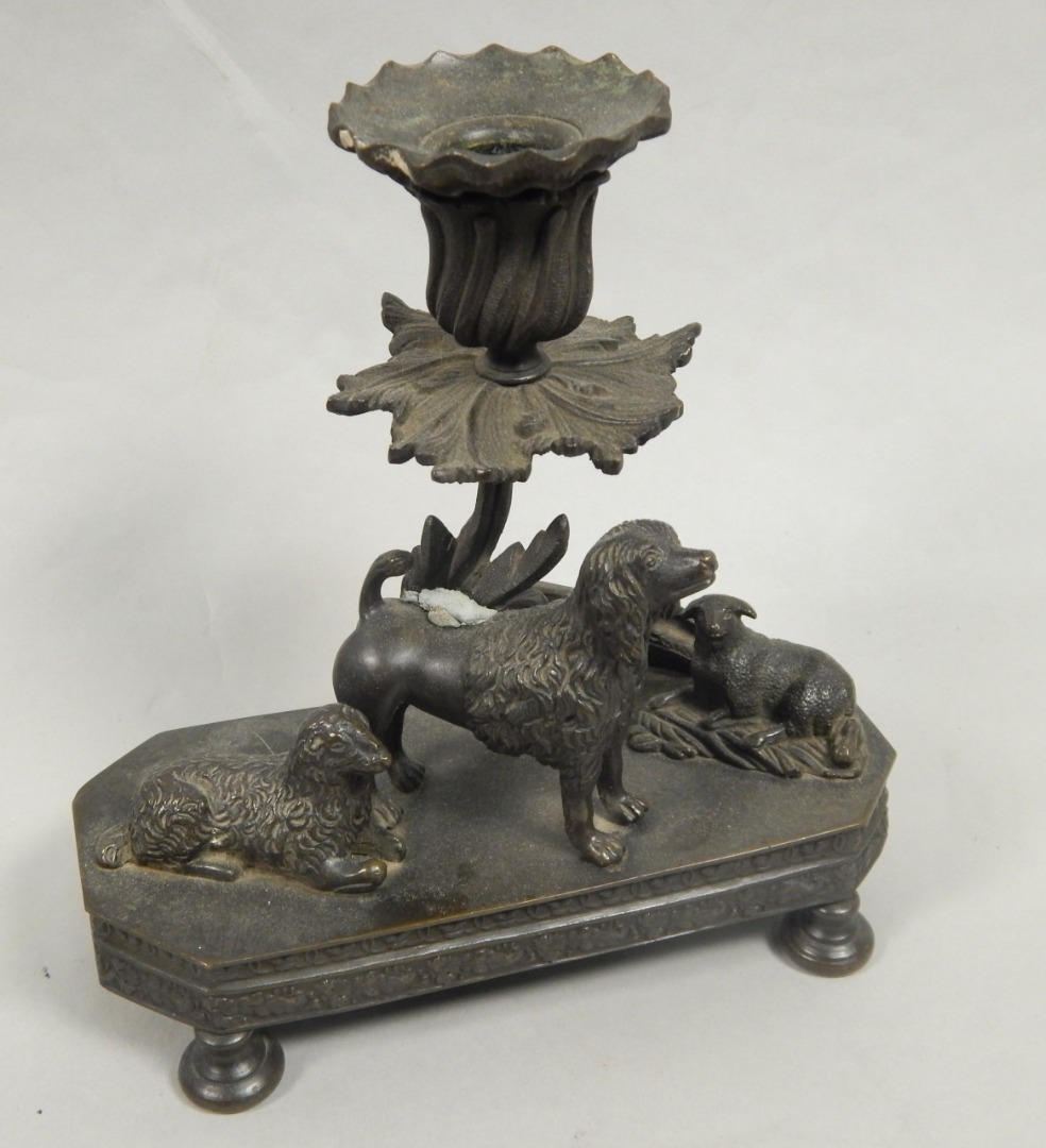 Appraisal: A mid thC bronze candlestick mounted with a poodle type