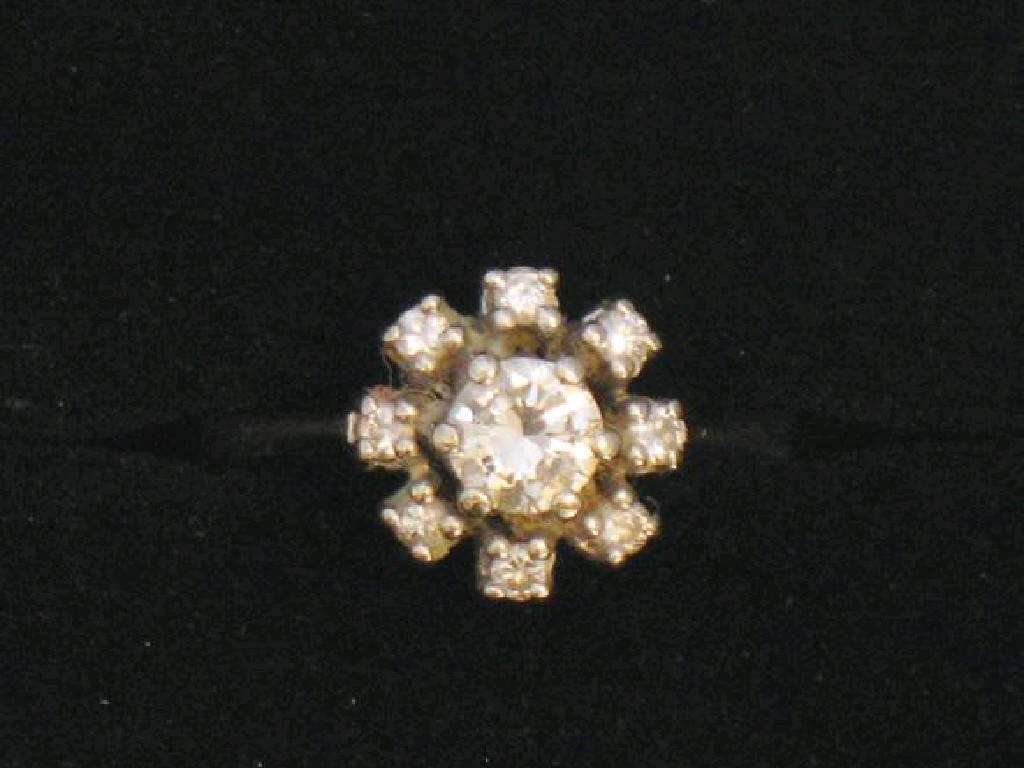 Appraisal: A 'S DIAMOND CLUSTER RING the central round brilliant-cut diamond