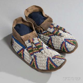 Appraisal: Lakota Beaded Buffalo Hide Moccasins c s with multicolored geometric