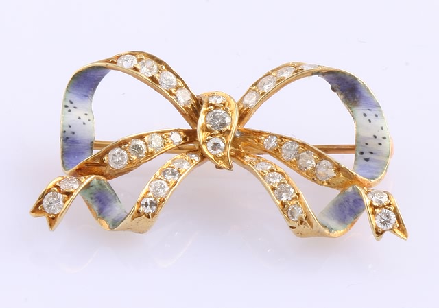 Appraisal: KY With enamel Bow Accented with - mm round diamonds