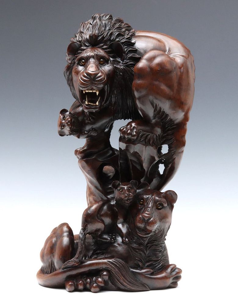 Appraisal: A DRAMATIC CARVED WOOD GROUPING OF GLASS-EYED LIONS The elaborate