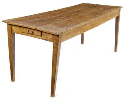 Appraisal: A French chestnut farmhouse table the boarded top above a