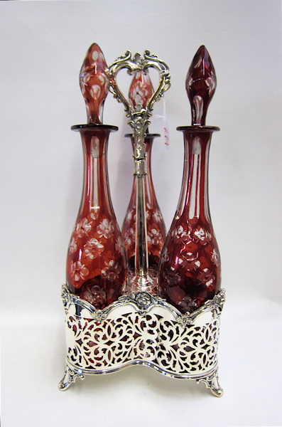 Appraisal: SET RUBY RED GLASS DECANTERS IN SILVER PLATED STAND the