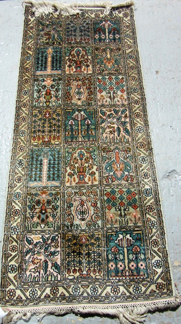 Appraisal: A small silk Kashmir garden runner with panels of trees