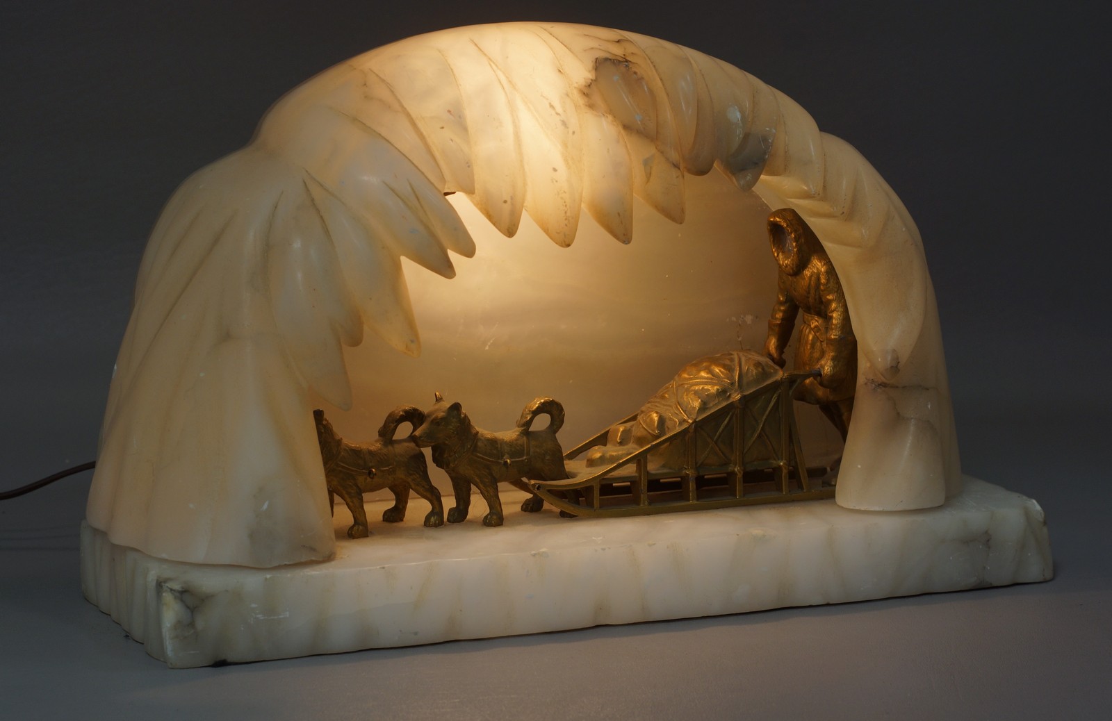 Appraisal: Carved Alabaster Ice Cave and Gilt Metal Dogsled Lamp the