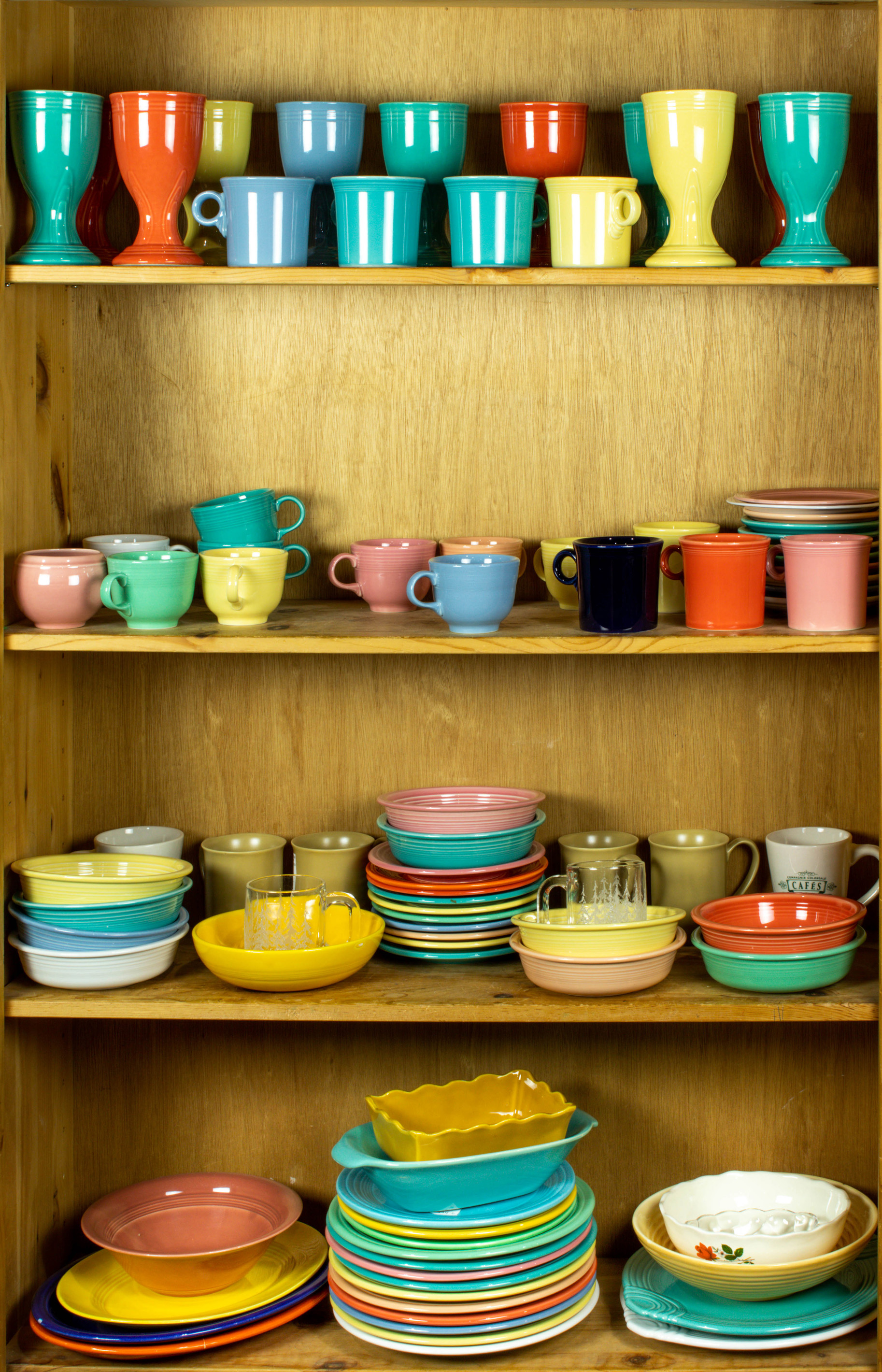 Appraisal: FOUR SHELVES OF ART POTTERY MOSTLY FIESTAWARE Four shelves of