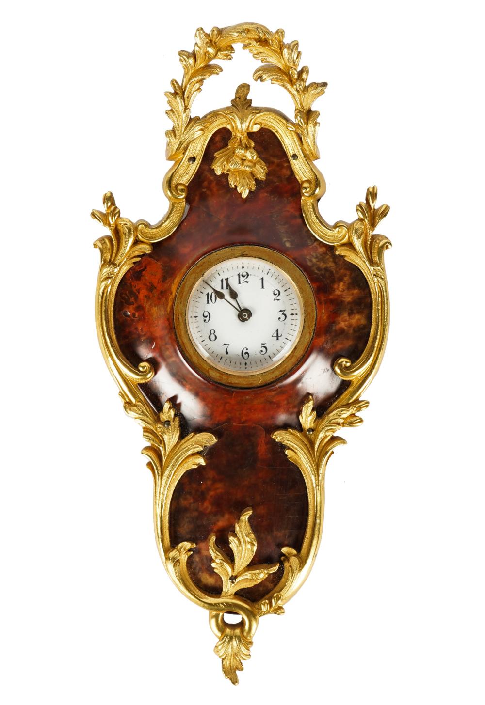 Appraisal: GILT METAL-MOUNTED CARTOUCHE CLOCKwood with faux tortoise painted finish unsigned