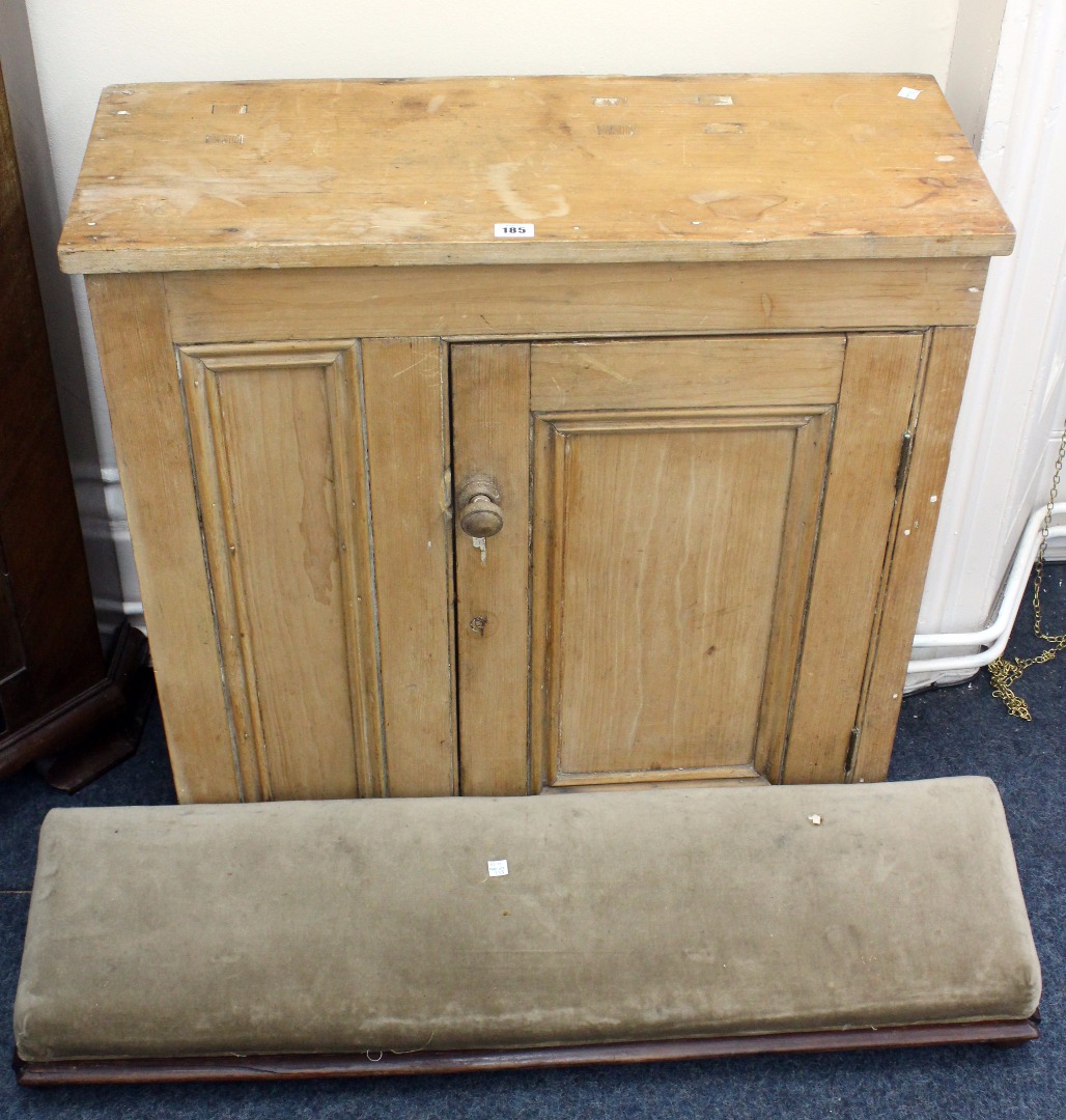 Appraisal: A small Victorian waxed pine cupboard enclosed by a door