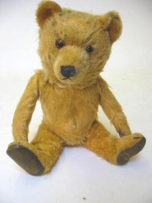 Appraisal: A Ting-a-Ling teddy bear covered in gold plush with swivel