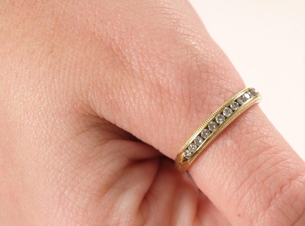 Appraisal: k yellow gold ring band channel set with thirteen round