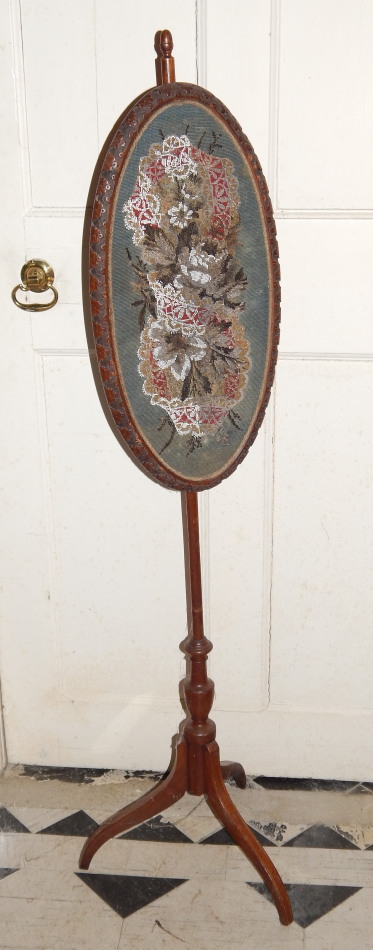 Appraisal: A thC mahogany pole screen with an oval banner inset