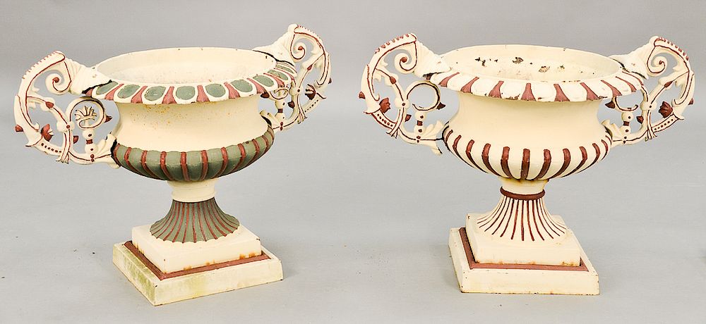 Appraisal: Pair of iron urns with scrolled handles on square bases