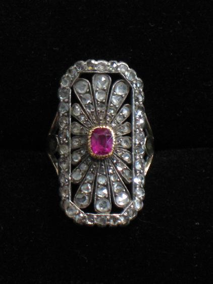 Appraisal: AN EDWARDIAN COCKTAIL RING of open rectangular form set to