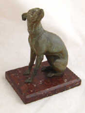 Appraisal: A bronze figure of an injured hound on red marble