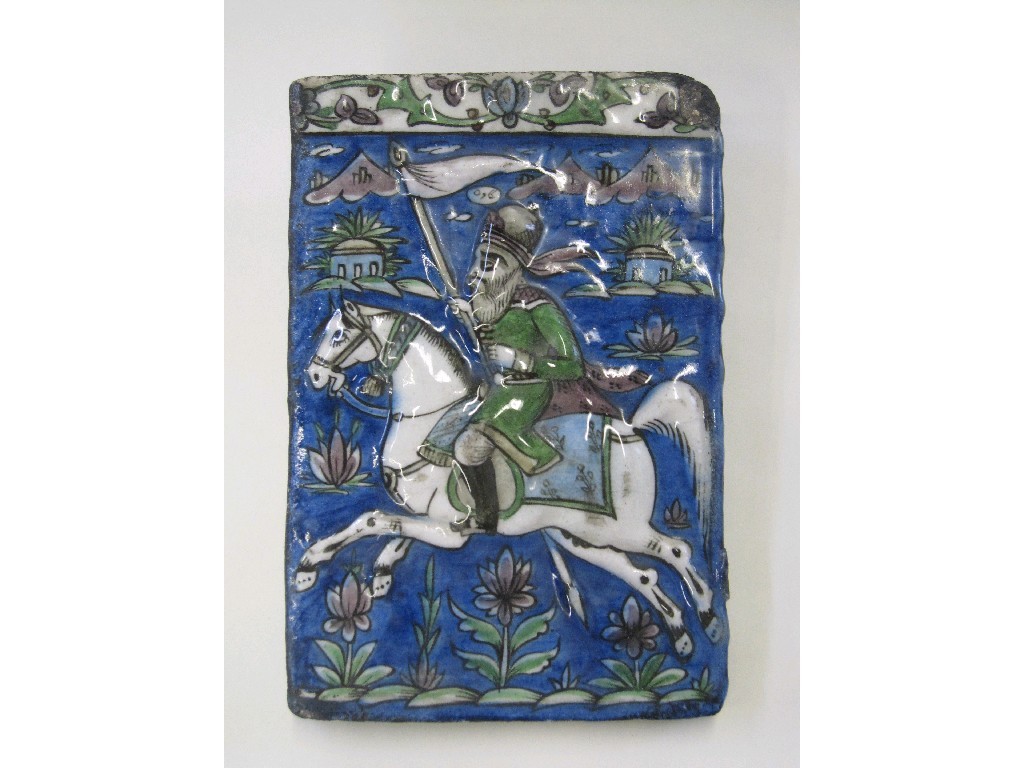 Appraisal: Persian tile depicting a man on horseback holding a standard