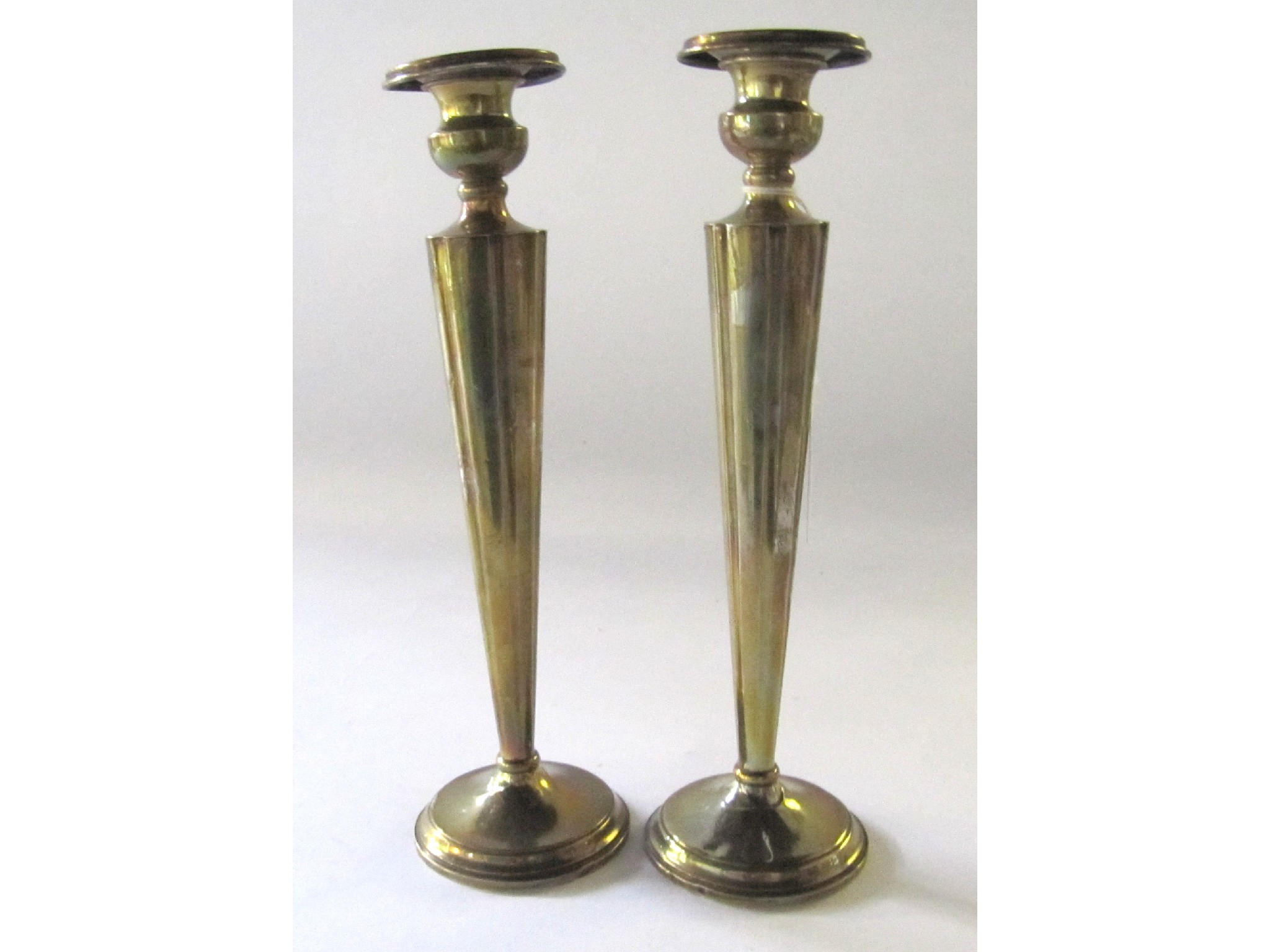 Appraisal: A pair of sterling silver candlesticks weighted