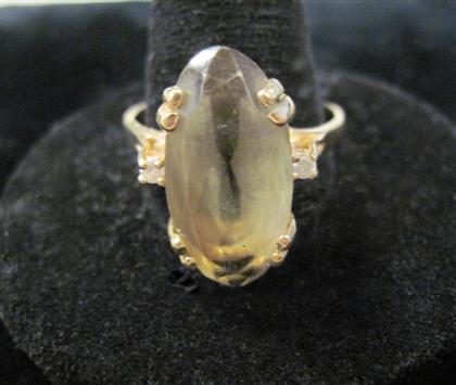 Appraisal: karat yellow gold smokey topaz and diamond ringOval faceted smokey