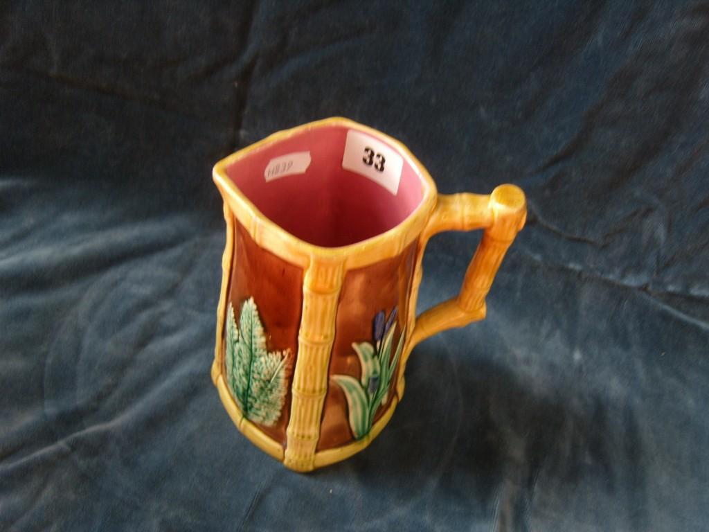 Appraisal: A th century majolica jug with simulated bamboo panels and