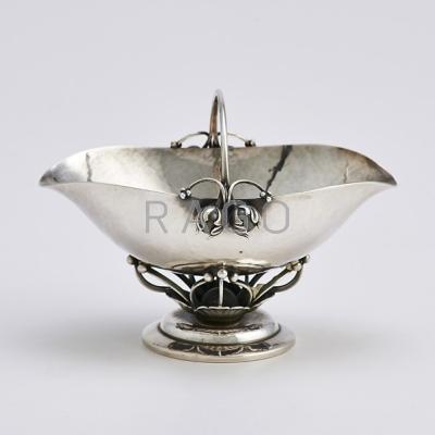 Appraisal: GEORG JENSEN STERLING SUGAR BASKET B Spot-hammered helmet-form stems and