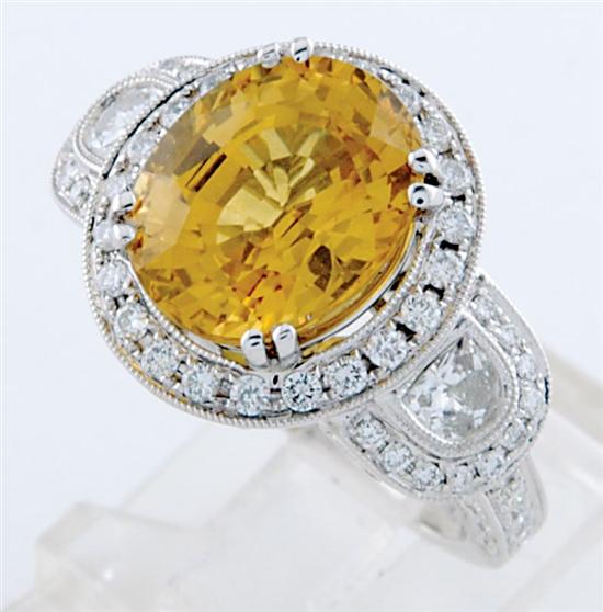 Appraisal: Sapphire and diamond ring centered by oval yellow sapphire ct