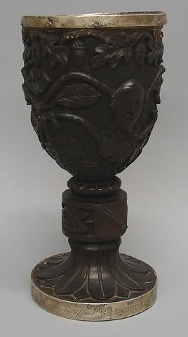 Appraisal: Heavily carved wooden goblet featuring head of Shakespeare sheep with