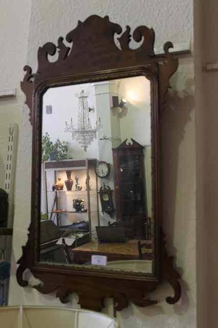 Appraisal: A CHIPPENDALE STYLE MAHOGANY WALL MIRROR with pierced decoration and