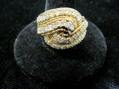 Appraisal: karat yellow gold and diamond 'swirl' ringTwo interlocking bands of