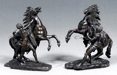 Appraisal: Pair bronze Marly horses rearing horses with attendants holding reins