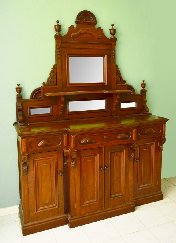 Appraisal: LARGE WALNUT EASTLAKE VICTORIAN SIDEBOARD Top with glass mirrors shelf