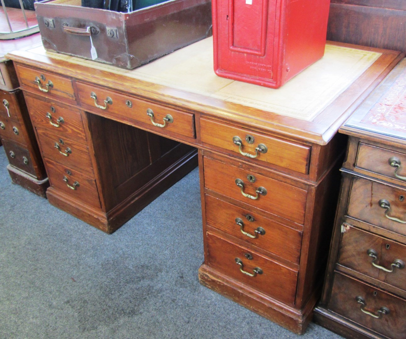 Appraisal: A th century pitch pine nine drawer pedestal desk on