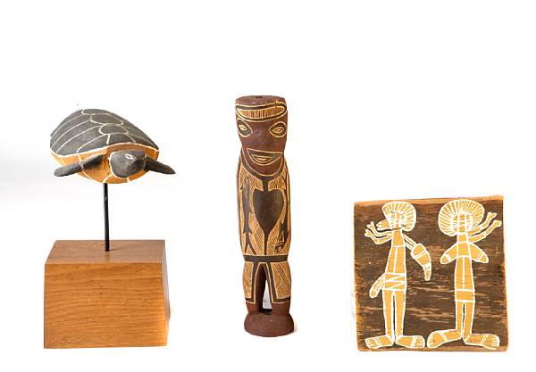 Appraisal: A group of nine painted wood aboriginal figures and paintings