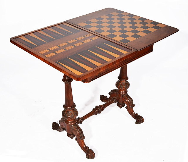 Appraisal: A VICTORIAN WALNUT GAMES TABLE with foldover top having inlaid