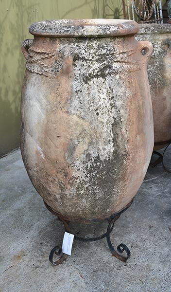 Appraisal: A FLOOR STANDING MOROCCAN EARTHENWARE URN ON A WROUGHT IRON