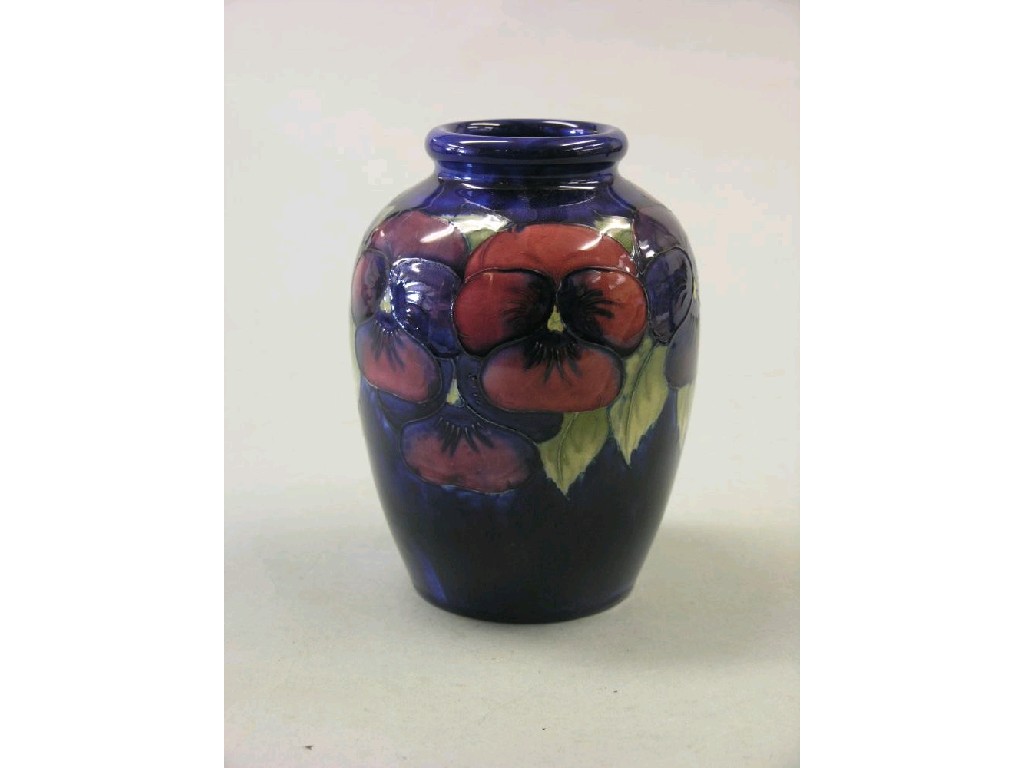 Appraisal: A Moorcroft vase 'Pansy' ovoid shape painted against deep blue