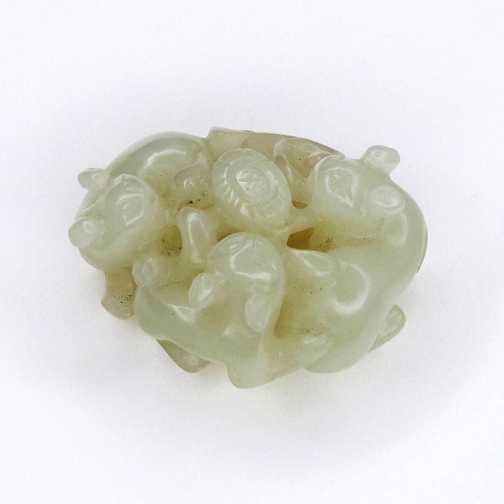 Appraisal: Early Chinese Jade Carving of Dogs with Flowers Chinese celadon