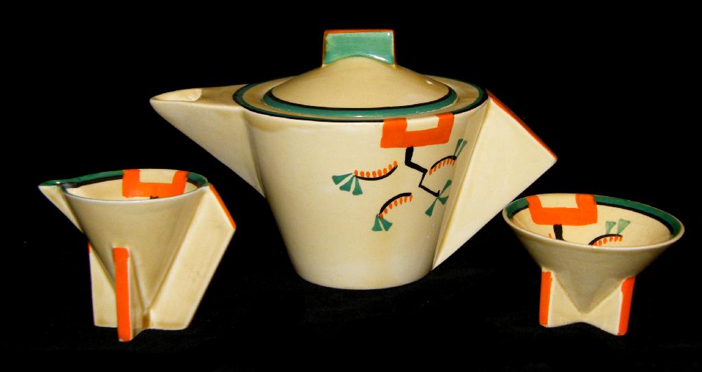 Appraisal: Ravel' Bizarre conical three piece bachelor tea service comprising teapot