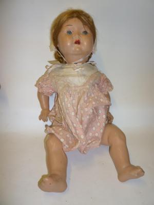 Appraisal: An English composition girl doll with blue glass sleeping eyes