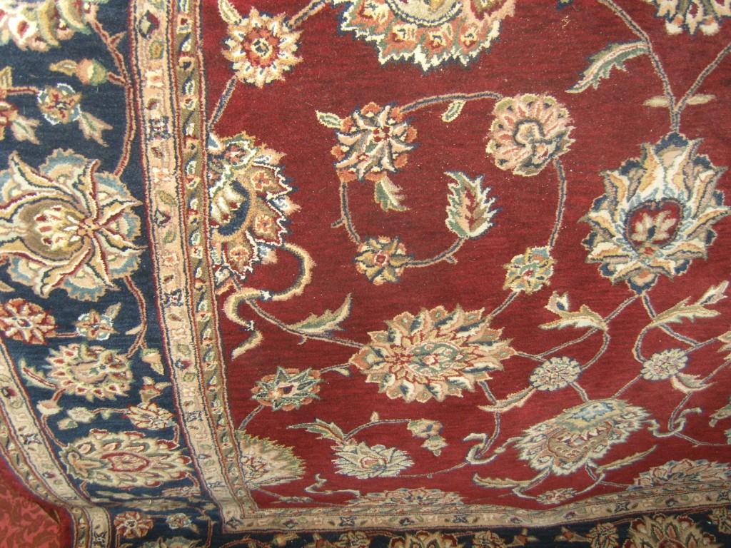 Appraisal: An eastern style wool rug with trailing floral decoration in