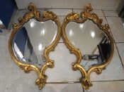 Appraisal: A pair of rococo gilt wood wall mirrors with bevelled