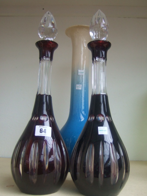 Appraisal: A pair of Bohemian ruby flash decanters and matched stoppers